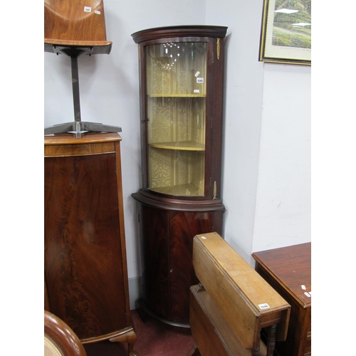 1595 - A Mahogany Bow Fronted Corner Cupboard, with a glazed door, over twin doors (with mounts) on bracket... 