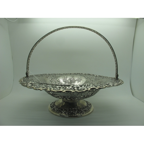 6 - Luen-Wo; A Chinese Swing Handled Pedestal Basket Dish, of allover blossom pierced design, with panel... 