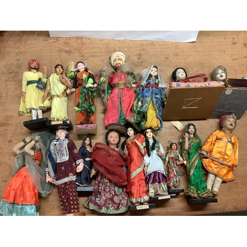 1419 - Fourteen Indian Costume Dolls, some on plinth bases others freestanding.