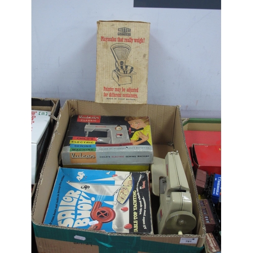 781 - Juvenalia - Four children's toys including a boxed Vulcan Classic child's electronic sewing machine,... 