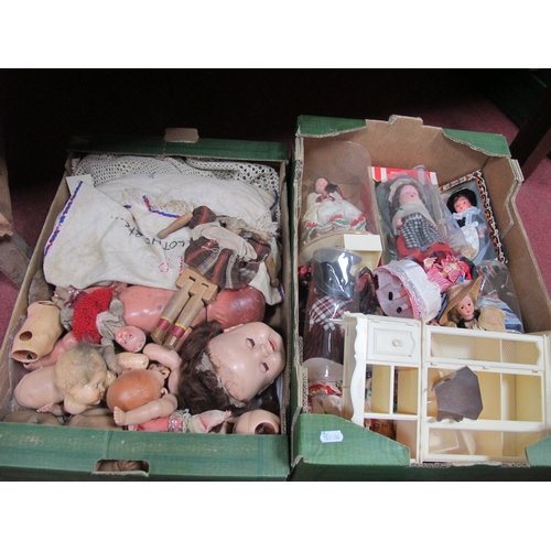 1114 - Dolls Heads and Parts, together with a box of souvenir dolls from different parts of the world:- Two... 