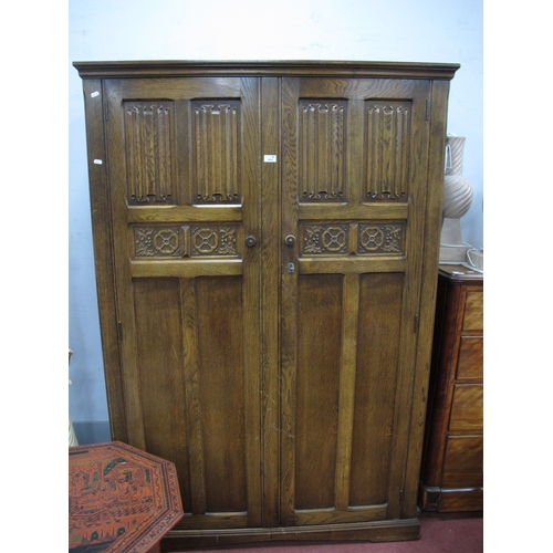 1553 - XX Century Oak Two Door Wardrobe with linen fold and paneled doors, 122cm wide.