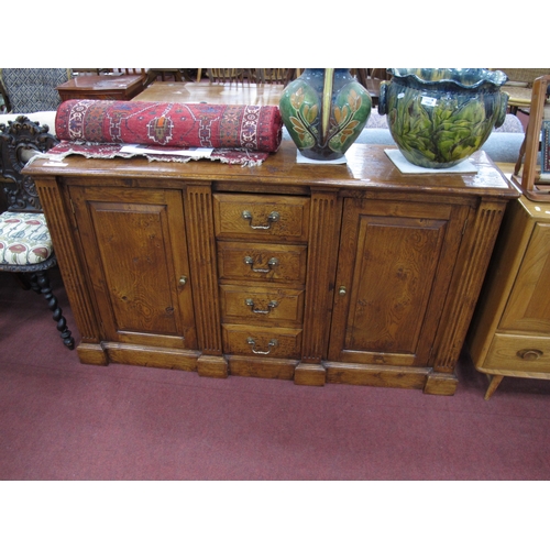 1562 - Oak Cabinet, with four central drawers, reeded columns flanking paneled cupboard doors, on a plinth ... 