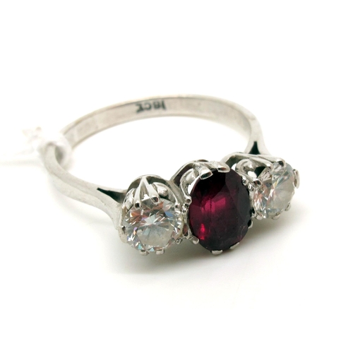 138 - A Ruby and Diamond Three Stone Ring, claw set with brilliant cut stones, stamped “18ct” (finger size... 