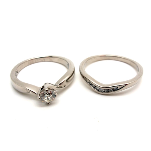 144 - A Modern (950) Palladium Single Stone Diamond Ring, four claw set between crossover style twisted sh... 