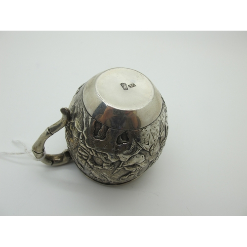 15 - A Chinese Cup, allover detailed in relief with battle scene, bamboo style handle, stamped character ... 