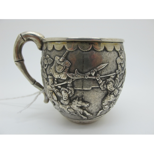 15 - A Chinese Cup, allover detailed in relief with battle scene, bamboo style handle, stamped character ... 