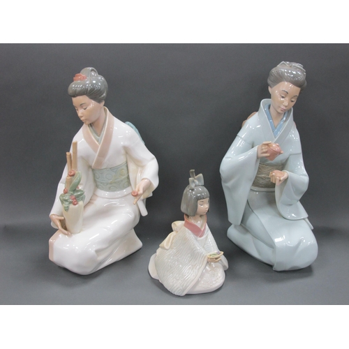 1050 - Two Nao Porcelain Figures of Japanese Ladies, one kneeling and holding a teapot and cup and holding ... 