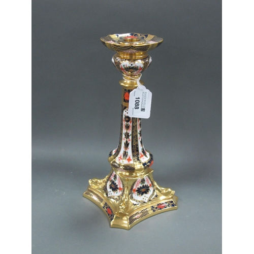 1088 - A Royal Crown Derby Porcelain Candlestick, the square base moulded with dolphins, decorated in Imari... 