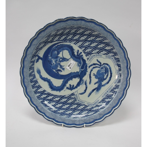 1168 - A Japanese Early XX Century Pottery Charger, of shaped circular form decorated in blue with a dragon... 