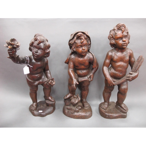 1229 - A Set of Three XIX Century Carved Wood Cupids, depicting the 'Seasons', 56cm high. (3)