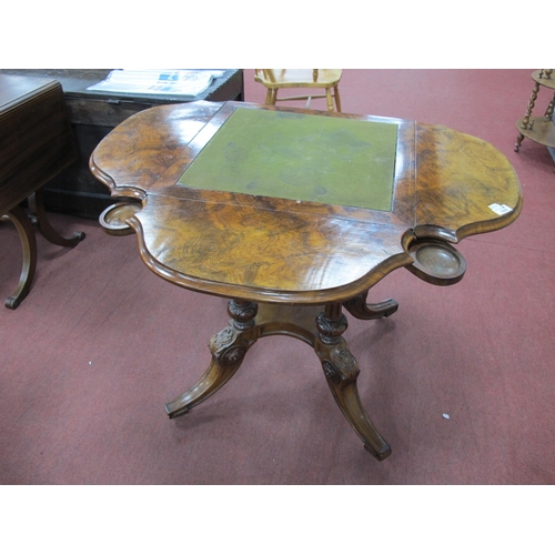 1559 - A Mid XIX Century Walnut Games Table, the top with baized insert, four shaped drop leaves and four g... 