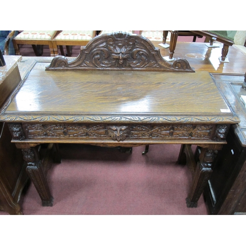 1570 - A XIX Century Carved Oak Side Table, with shaped back carved with a head, single drawer on fruit car... 