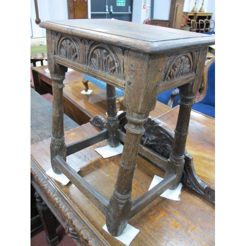 1587 - A XVII Century Joined Oak Stool, the top with moulded edge and lunette carving to frieze, on turned ... 