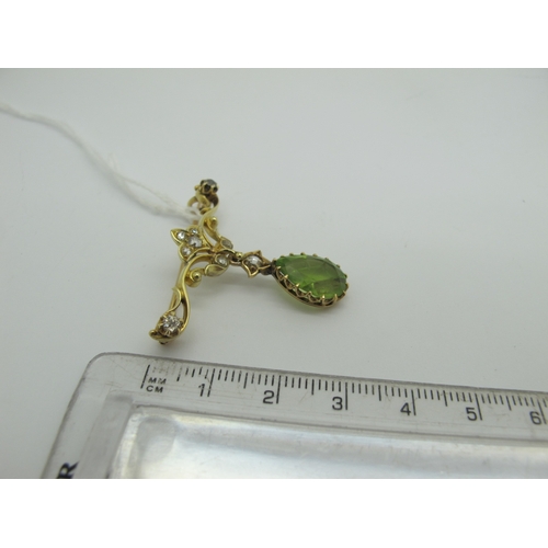 76 - An Edwardian Peridot and Diamond Set Pendant Brooch, teardrop claw set (stone crack) below scroll ba... 