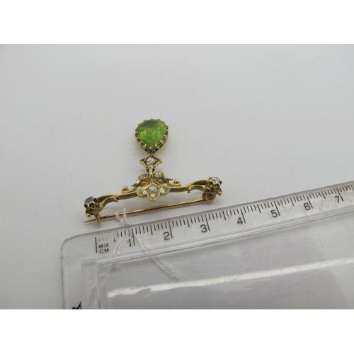 76 - An Edwardian Peridot and Diamond Set Pendant Brooch, teardrop claw set (stone crack) below scroll ba... 