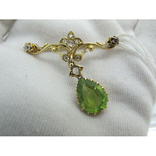 76 - An Edwardian Peridot and Diamond Set Pendant Brooch, teardrop claw set (stone crack) below scroll ba... 