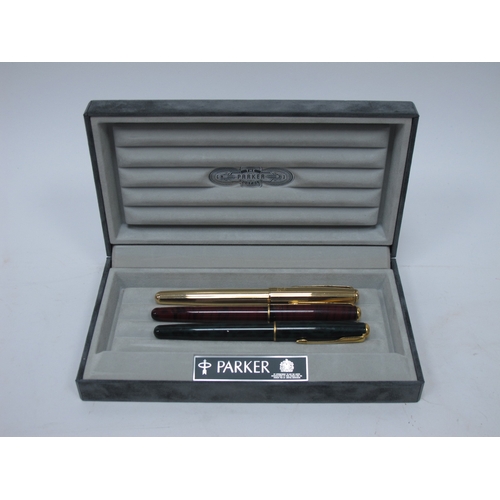 1199 - Three Parker 'Sonnet' Fountain Pens, in a mottled green, mottled red and yellow metal cases, boxed, ... 