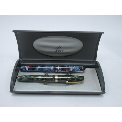 1199 - Three Parker 'Sonnet' Fountain Pens, in a mottled green, mottled red and yellow metal cases, boxed, ... 