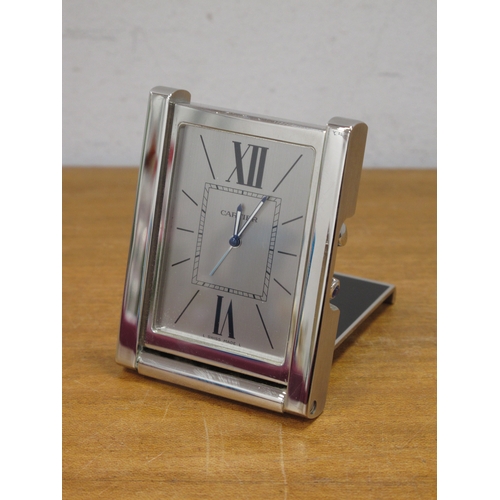 1177 - A Cartier Stainless Steel Bedside Clock, of rectangular fol-out form, the dial with Roman numerals a... 