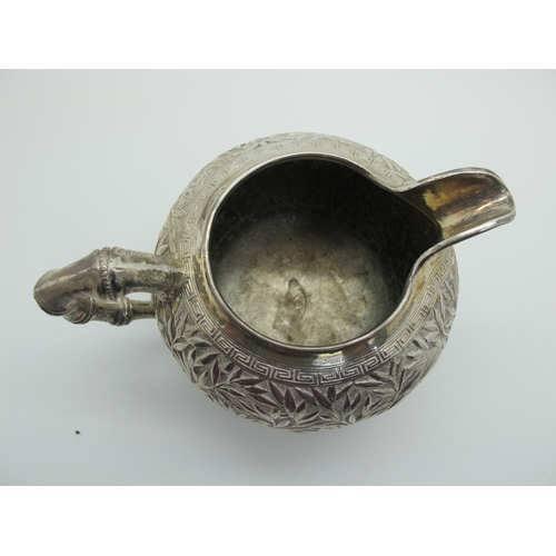 17 - A Chinese Three Piece Tea Set, each allover detailed in relief with bamboo (indistinctly stamped cha... 