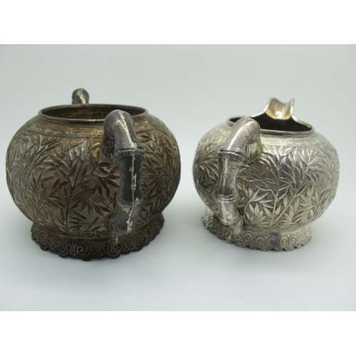 17 - A Chinese Three Piece Tea Set, each allover detailed in relief with bamboo (indistinctly stamped cha... 