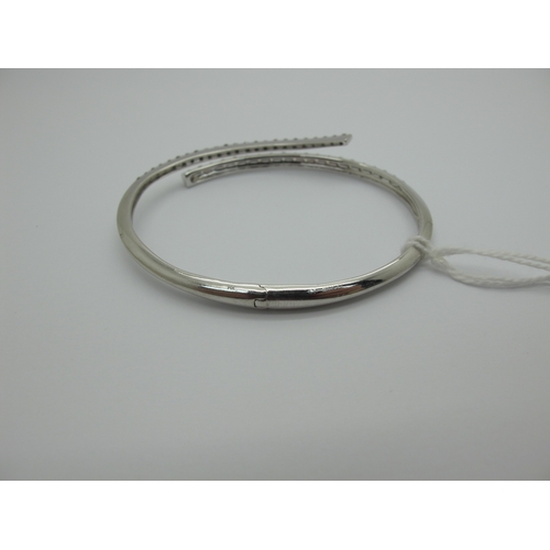 98 - A Modern Diamond Set Bangle, of crossover design to the front, set with graduated brilliant cut diam... 