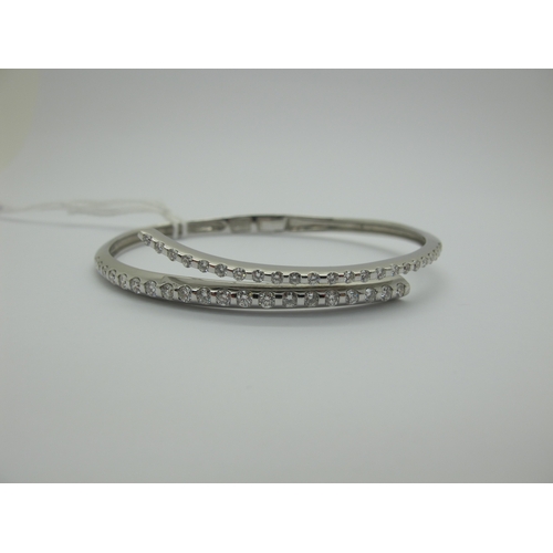 98 - A Modern Diamond Set Bangle, of crossover design to the front, set with graduated brilliant cut diam... 