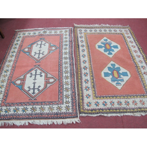 1587 - Middle Eastern Wool Tassled Rugs, each with twin geometric gul to center, both on pink ground within... 