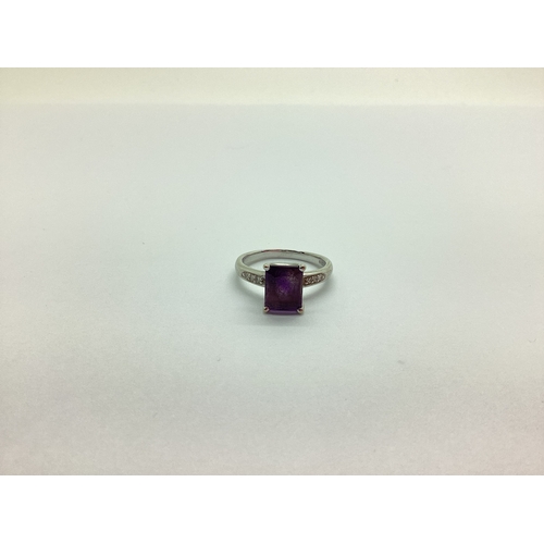 222 - A Modern Amethyst and Diamond Dress Ring, rectangular claw set to the centre, high between diamond s... 