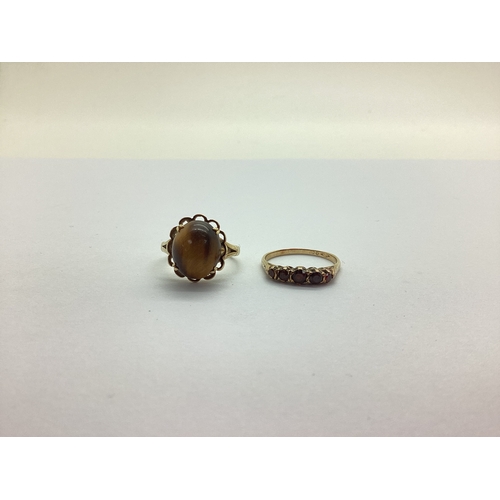 229 - A Cabochon Claw Set Ring, within an openwork border, between bifurcated shoulders, stamped 