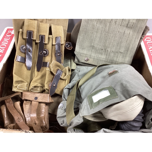 725 - Items of Military equipment comprising respirator, canvas and leather webbing from various eras and ... 