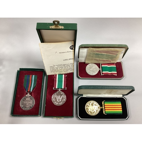 868 - Two Women's Voluntary Service Medals, A Hallmarked Silver Voluntary Service medal and a Vietnam Vete... 