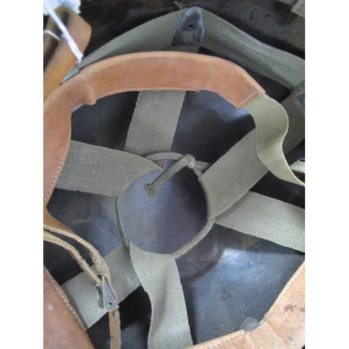 768 - United States M1 combat helmet liner with webbing cradle and leather chin strap.