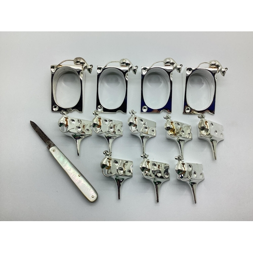 105 - Silea Silver Plated Cheese Marker / Menu Holders, together with a novelty cheese and mouse napkin ri... 