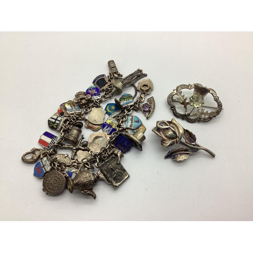 164 - Vintage Charm Bracelet, suspending numerous assorted novelty charm and souvenir enamel shield pendan... 