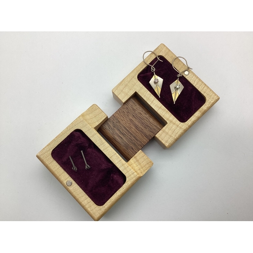 180 - A Pair of Modern 18ct Two Colour Gold Drop Earrings, of Modernist style with claw set highlights, ho... 