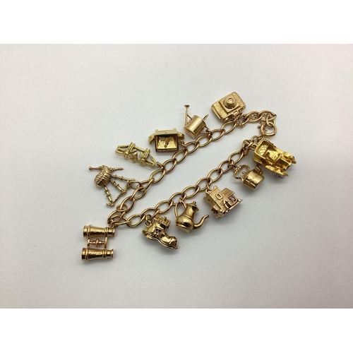 188 - A 9ct Gold Curb Link Charm Bracelet, suspending assorted novelty charm pendants including telephone,... 