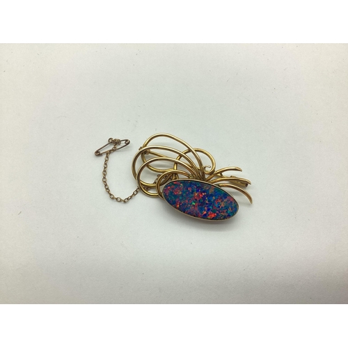 201 - A Black Opal (Doublet?) Openwork Brooch, of abstract design, oval collet set (closed back setting), ... 