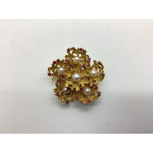 207 - A Ruby and Pearl Set Flowerhead Brooch, of allover textured and pierced finish, set with six pearls ... 