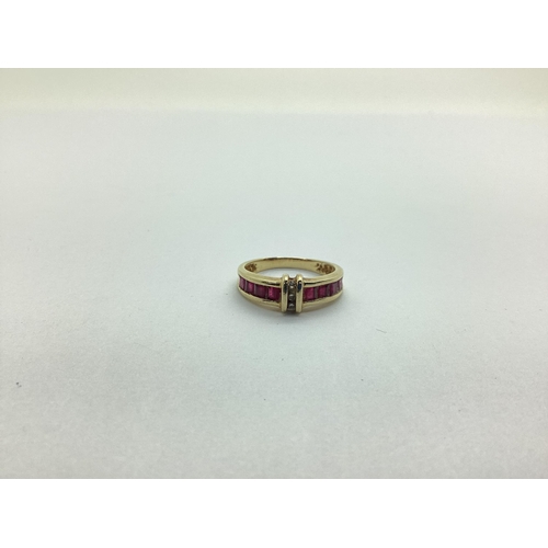 227 - A Modern Ruby and Diamond Set Dress Ring, channel set with uniform stones, indistinctly stamped 