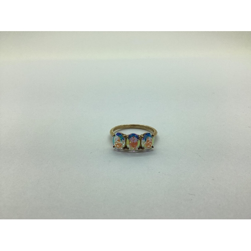 233 - A 9ct Gold Modern Three Stone Dress Ring, claw set (finger size N) (2.2grams).