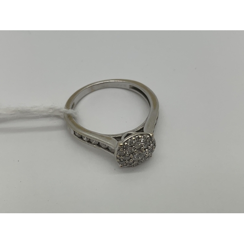 209 - A Modern 18ct White Gold Diamond Cluster Ring, set throughout with graduated brilliant cut stones, b... 