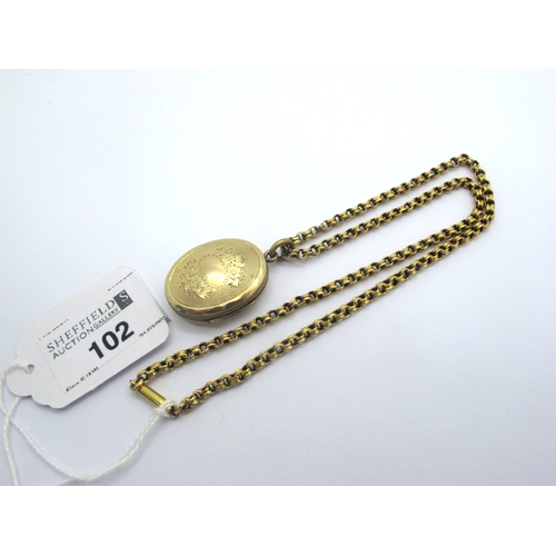 102 - An Antique Oval Locket, allover engine turned, on reeded belcher link chain.