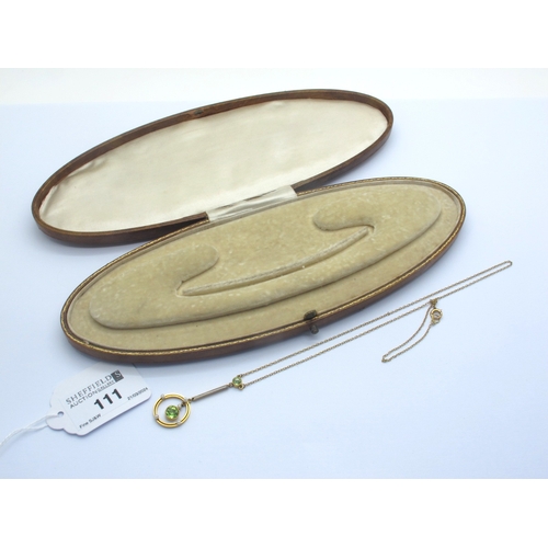 111 - An Edwardian Drop Pendant, the circular drop with central articulated collet set peridot, on bar dro... 
