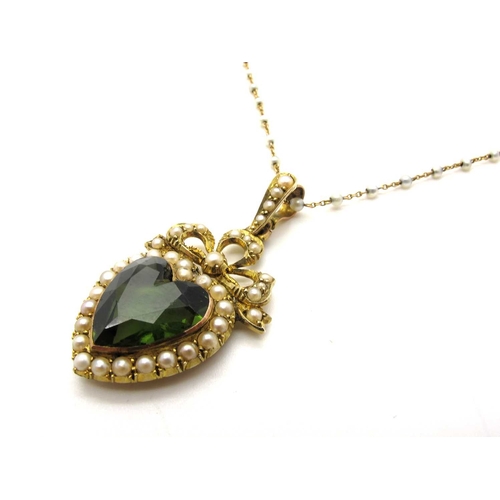103 - An Edwardian Heart Shape Green Tourmaline and Pearl Set Pendant, collet set within pearl set border,... 