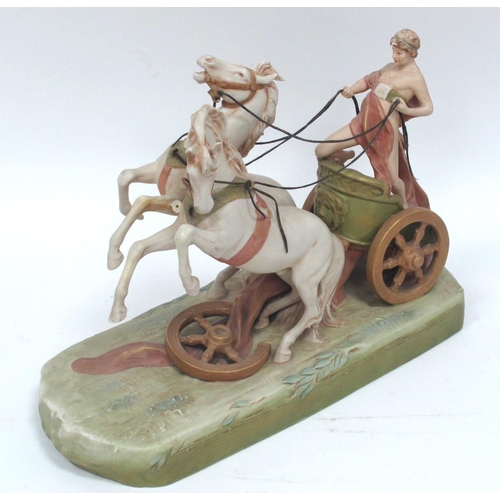 1022 - A Royal Dux Pottery Model of a Young Man Riding a Chariot Pulled by Two Rearing Horses, on a natural... 