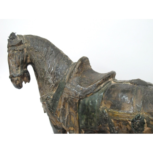 1145 - A Large Chinese Tang Style Pottery Horse, his front left leg aloft, on a wooden base, 50cm long.