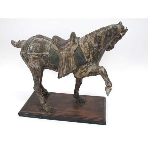 1145 - A Large Chinese Tang Style Pottery Horse, his front left leg aloft, on a wooden base, 50cm long.