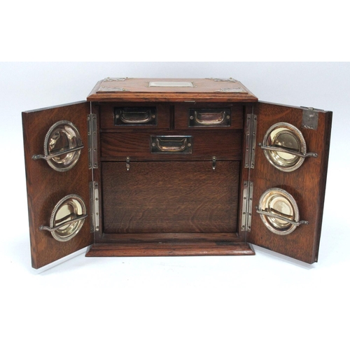 1266 - An Early XX Century Oak Cased Smokers Cabinet, of rectangular form with plated mounts and side carry... 